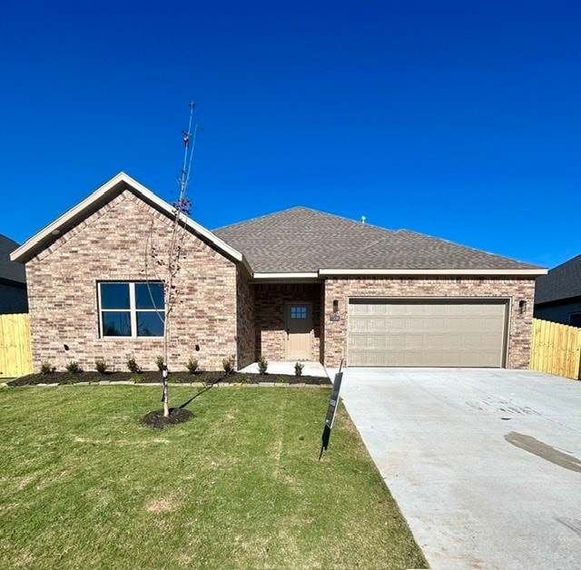 view of front of property with a front yard and a garage