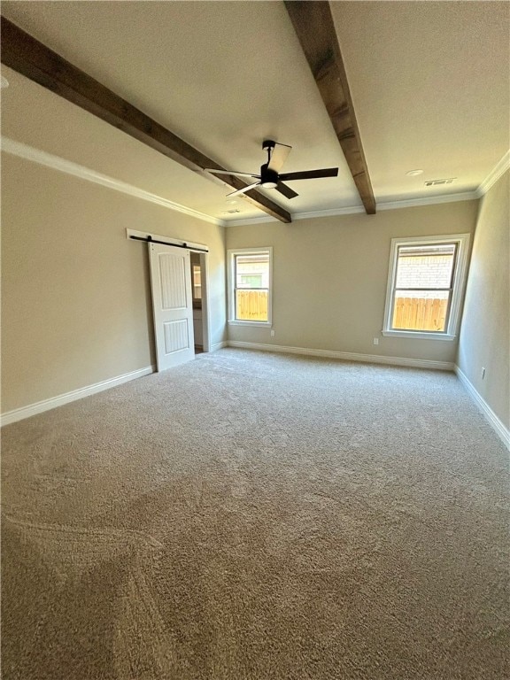 carpeted spare room featuring beam ceiling, a barn door, crown molding, and a textured ceiling