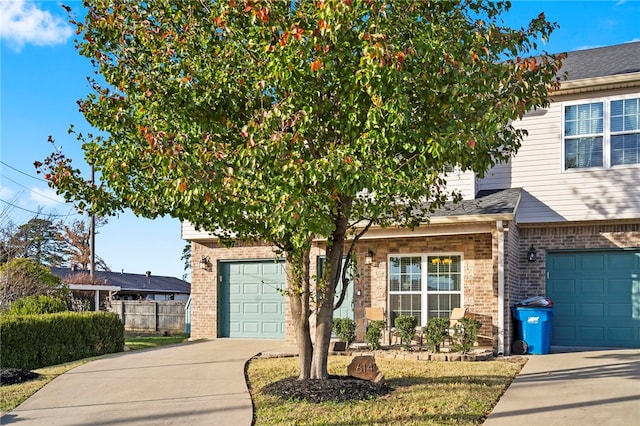 view of property hidden behind natural elements with a garage