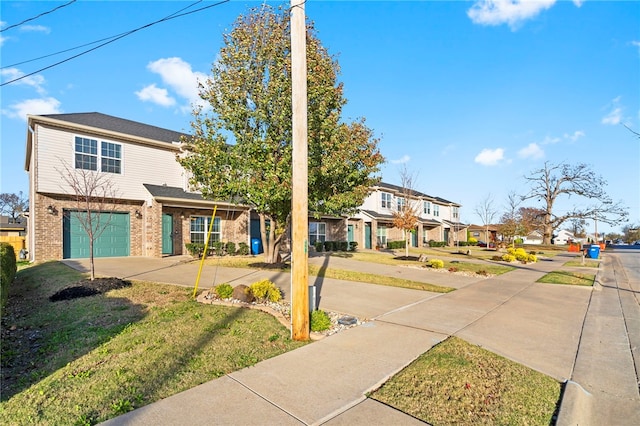 view of front of home with a garage and a front lawn