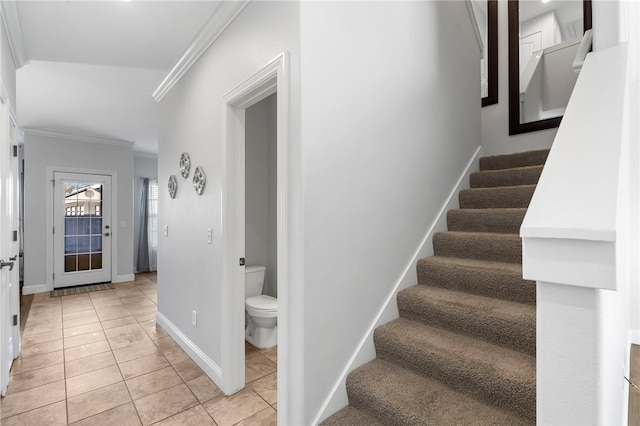 stairway featuring tile patterned flooring and crown molding