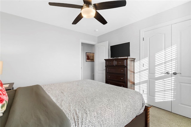 bedroom featuring carpet flooring, ceiling fan, and a closet