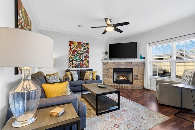 living room featuring ceiling fan, dark hardwood / wood-style flooring, ornamental molding, and a fireplace