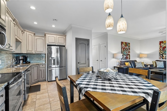 dining space with light tile patterned floors, crown molding, and sink