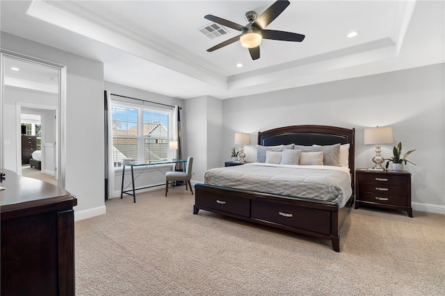 carpeted bedroom featuring a raised ceiling and ceiling fan