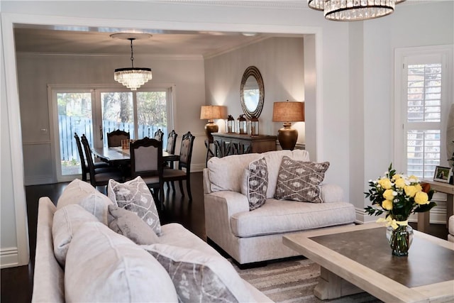 living room featuring hardwood / wood-style floors, crown molding, and a chandelier