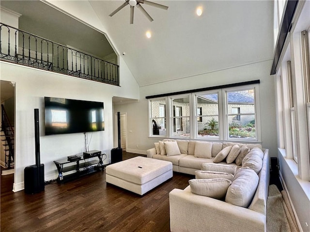 living room with ceiling fan, dark wood-type flooring, and high vaulted ceiling