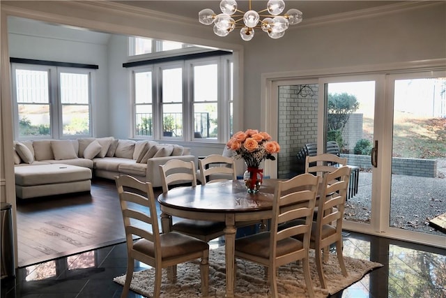 dining area featuring crown molding, plenty of natural light, dark wood-type flooring, and a notable chandelier