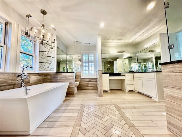 full bathroom featuring vanity, decorative backsplash, separate shower and tub, toilet, and a notable chandelier