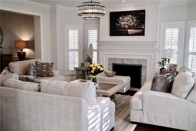 living room with plenty of natural light, dark hardwood / wood-style floors, ornamental molding, and a tile fireplace