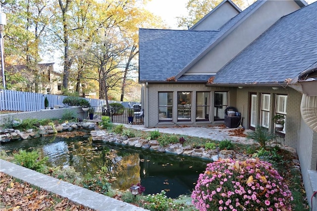 exterior space with a garden pond