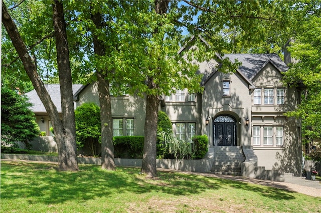 view of front of house with brick siding and a front yard