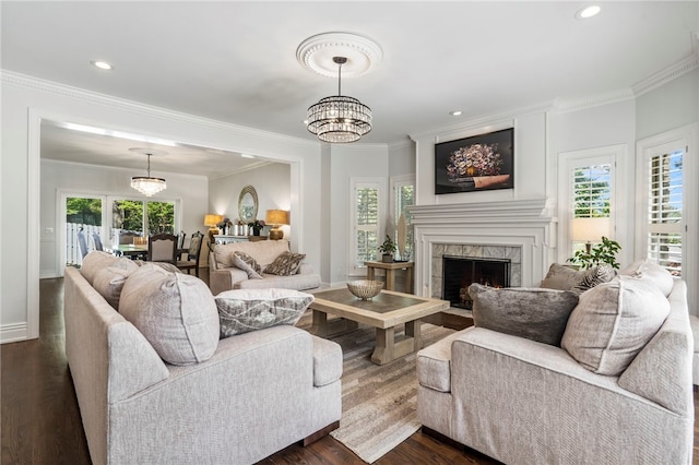 living area with dark wood-type flooring, a high end fireplace, and crown molding