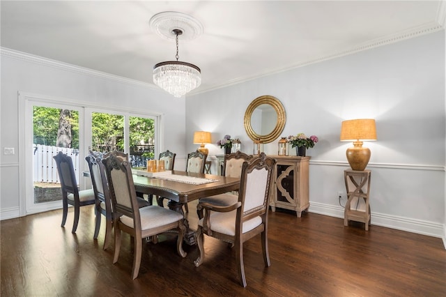dining space featuring an inviting chandelier, baseboards, ornamental molding, and wood finished floors