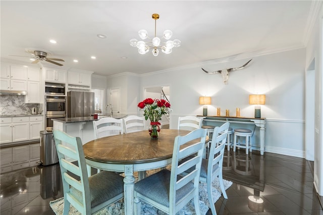 dining space featuring recessed lighting, ornamental molding, baseboards, and ceiling fan with notable chandelier