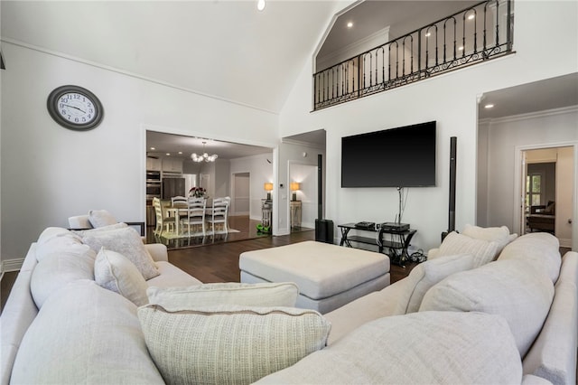 living area with crown molding, an inviting chandelier, high vaulted ceiling, baseboards, and wood finished floors