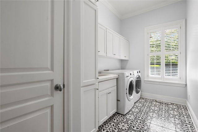laundry area with crown molding, baseboards, cabinet space, and washer and clothes dryer
