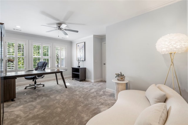 carpeted office with ceiling fan, visible vents, ornamental molding, and baseboards