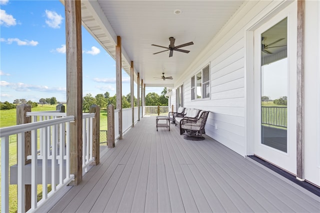 wooden deck featuring ceiling fan and covered porch