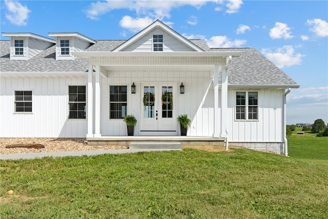 view of front facade with covered porch and a front yard