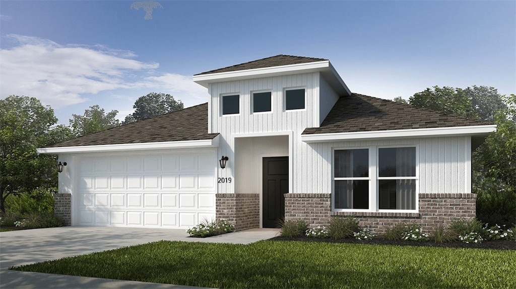 view of front of house featuring a garage and a front lawn