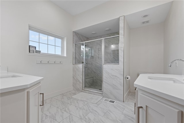 bathroom featuring a shower with door and vanity