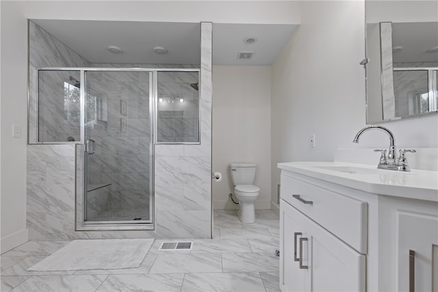 bathroom featuring vanity, an enclosed shower, and toilet