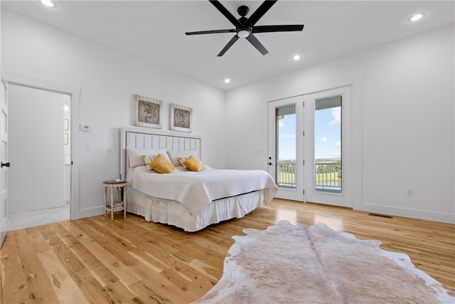 bedroom featuring hardwood / wood-style flooring, ceiling fan, and access to outside