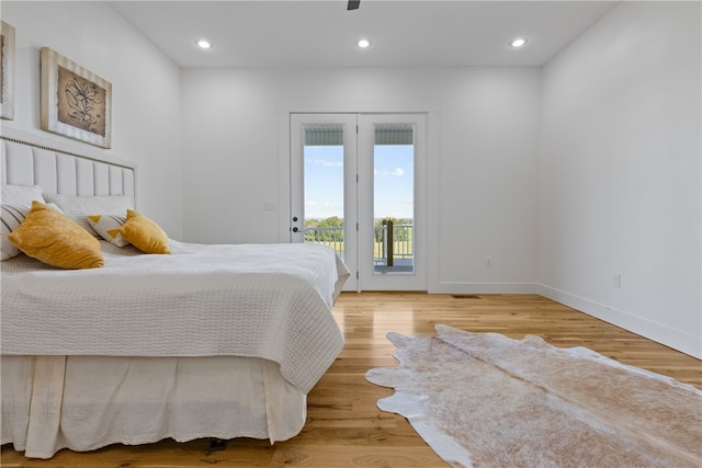 bedroom featuring access to exterior and light hardwood / wood-style floors