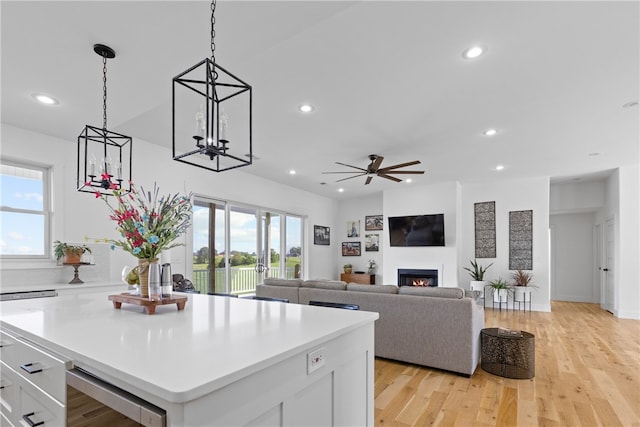 kitchen featuring plenty of natural light, light hardwood / wood-style floors, white cabinetry, and beverage cooler