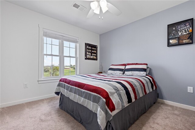 bedroom with ceiling fan and light colored carpet