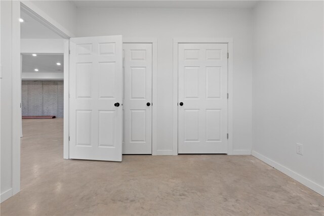 unfurnished bedroom with two closets