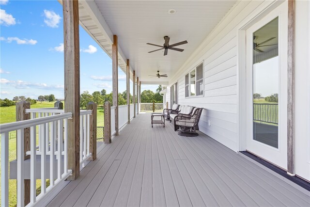 wooden deck with a porch and ceiling fan