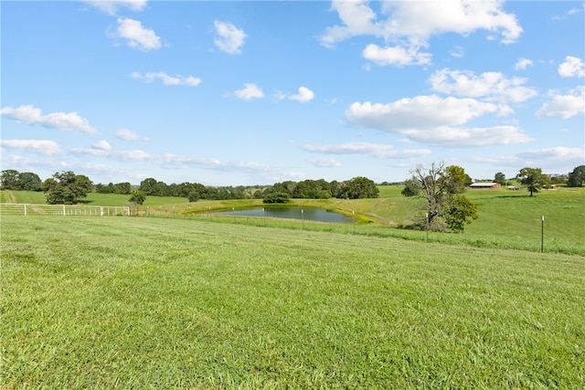 view of yard featuring a water view and a rural view