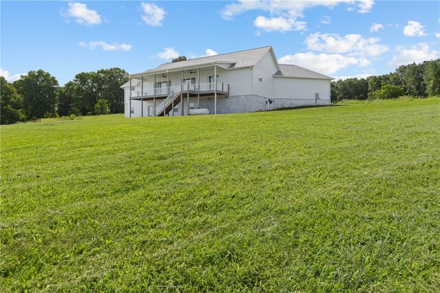 back of house with a wooden deck and a yard