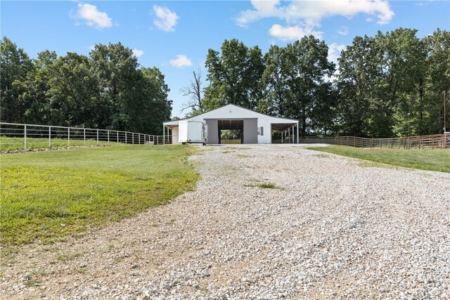 exterior space featuring a lawn and a rural view