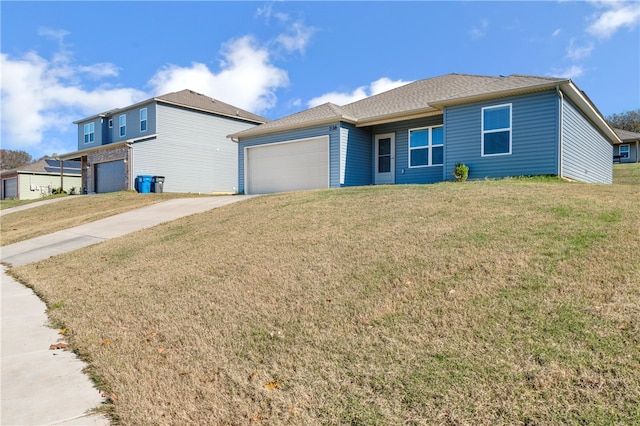 view of front facade with a front yard and a garage