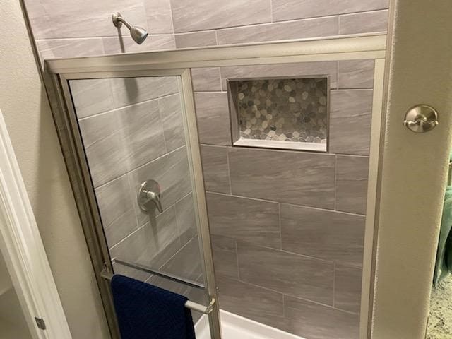 bathroom with a tile shower