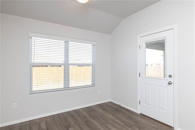 empty room with dark hardwood / wood-style flooring and lofted ceiling