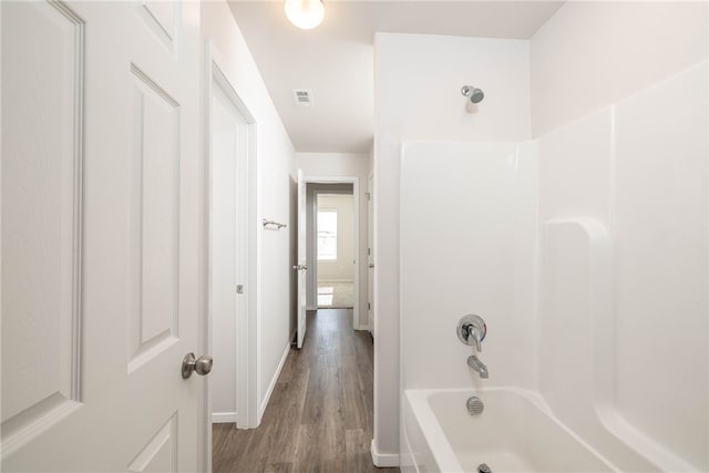 bathroom featuring  shower combination and wood-type flooring