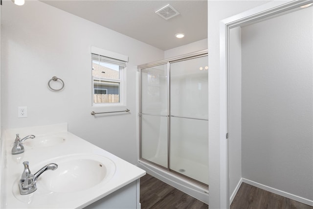 bathroom with vanity, wood-type flooring, and an enclosed shower