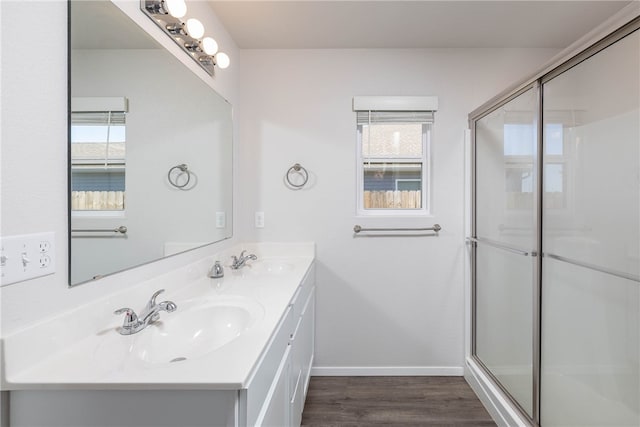 bathroom with vanity, wood-type flooring, and a shower with shower door