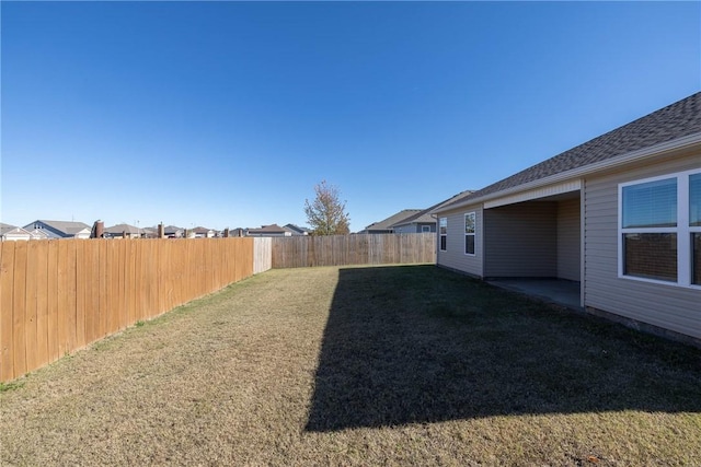 view of yard with a fenced backyard