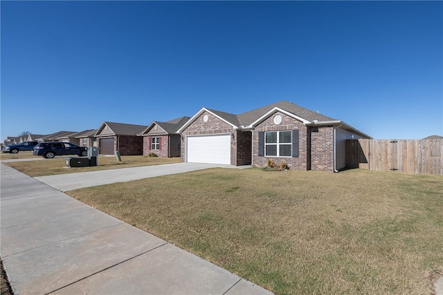 ranch-style home featuring driveway, fence, a front yard, an attached garage, and brick siding