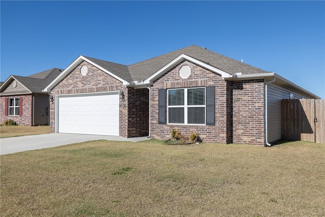 view of front of home with a front yard and a garage