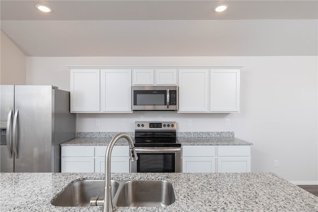 kitchen with sink, white cabinets, and appliances with stainless steel finishes