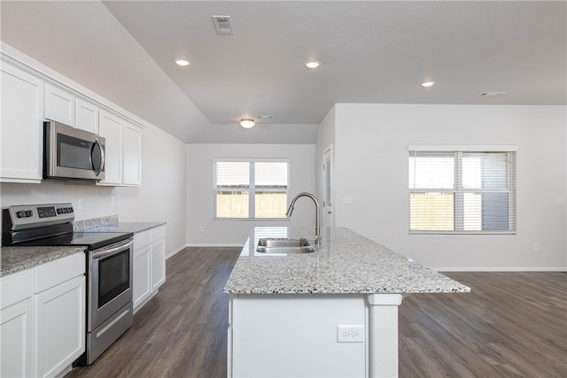 kitchen with stainless steel appliances, dark wood-type flooring, sink, a center island with sink, and white cabinets