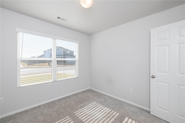 unfurnished room featuring visible vents, baseboards, and carpet flooring