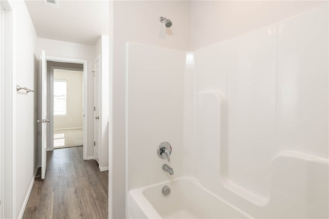 bathroom featuring  shower combination and wood-type flooring