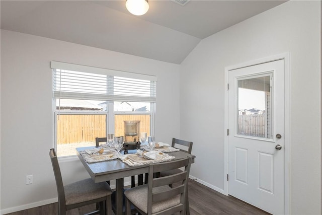 dining room with baseboards, lofted ceiling, and dark wood finished floors